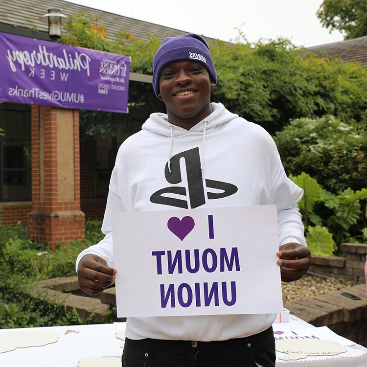 Mount Union student holding a I heart Mount Union sign.